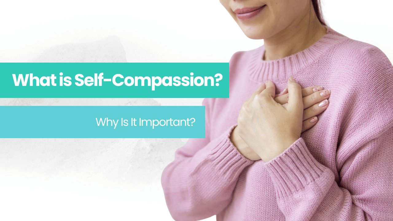 A woman in a pink sweater is holding her hands to her chest showing Self-Compassion