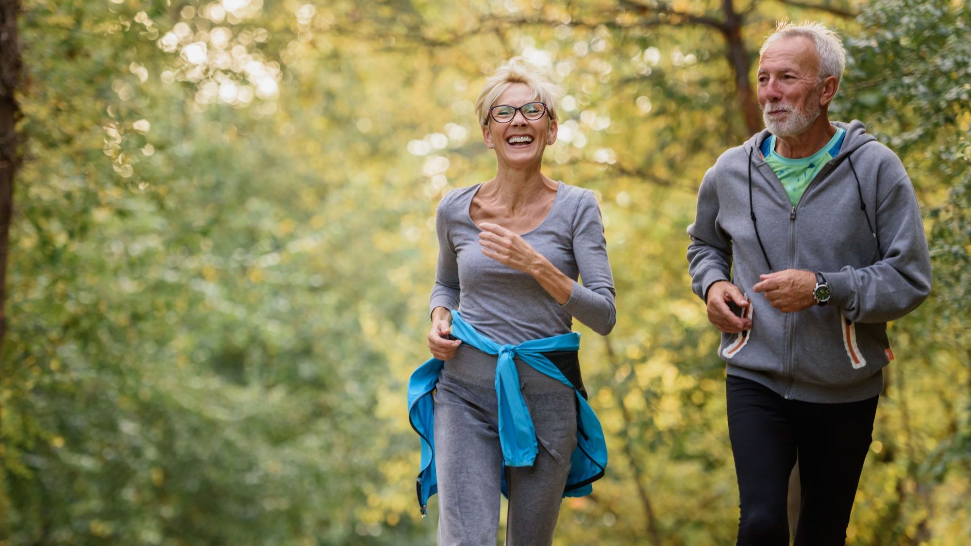 Active older couple jogging outdoors, representing safe exercise for nerve health and neuropathy recovery