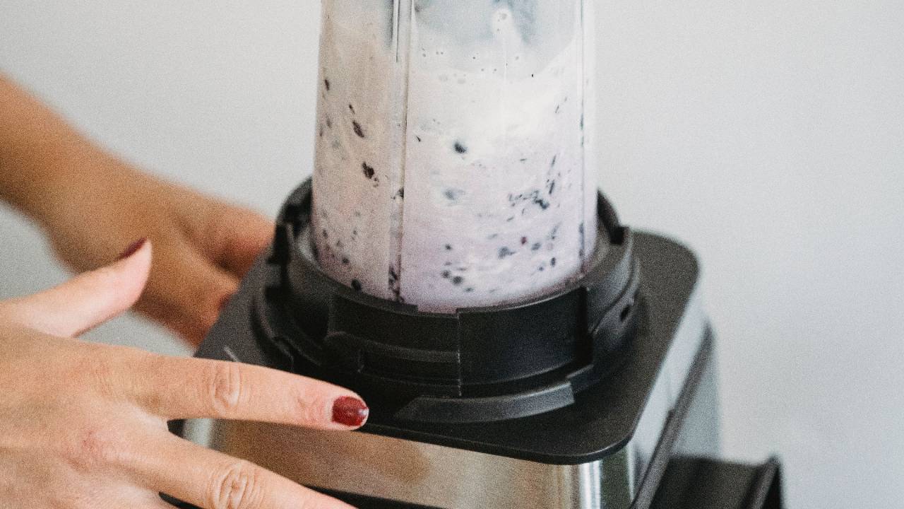 Blender with fresh fruits supporting gut health and skin wellness