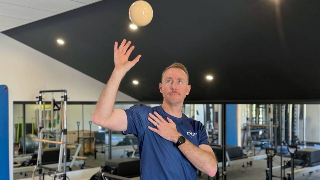Physio demonstrating plyo ball exercise