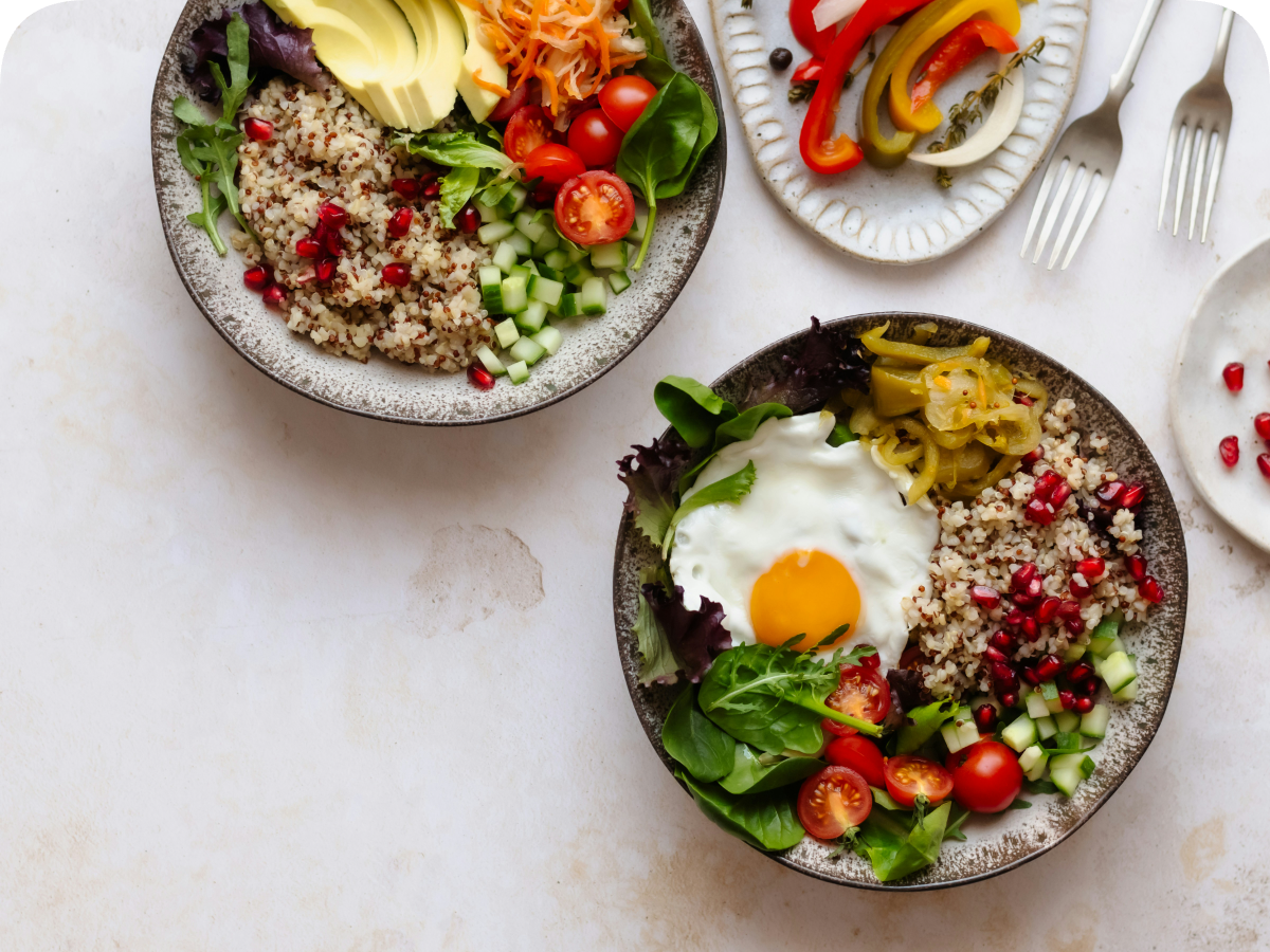 Protein-anchored brunch bowl with quinoa, greens, egg, and fresh vegetables
