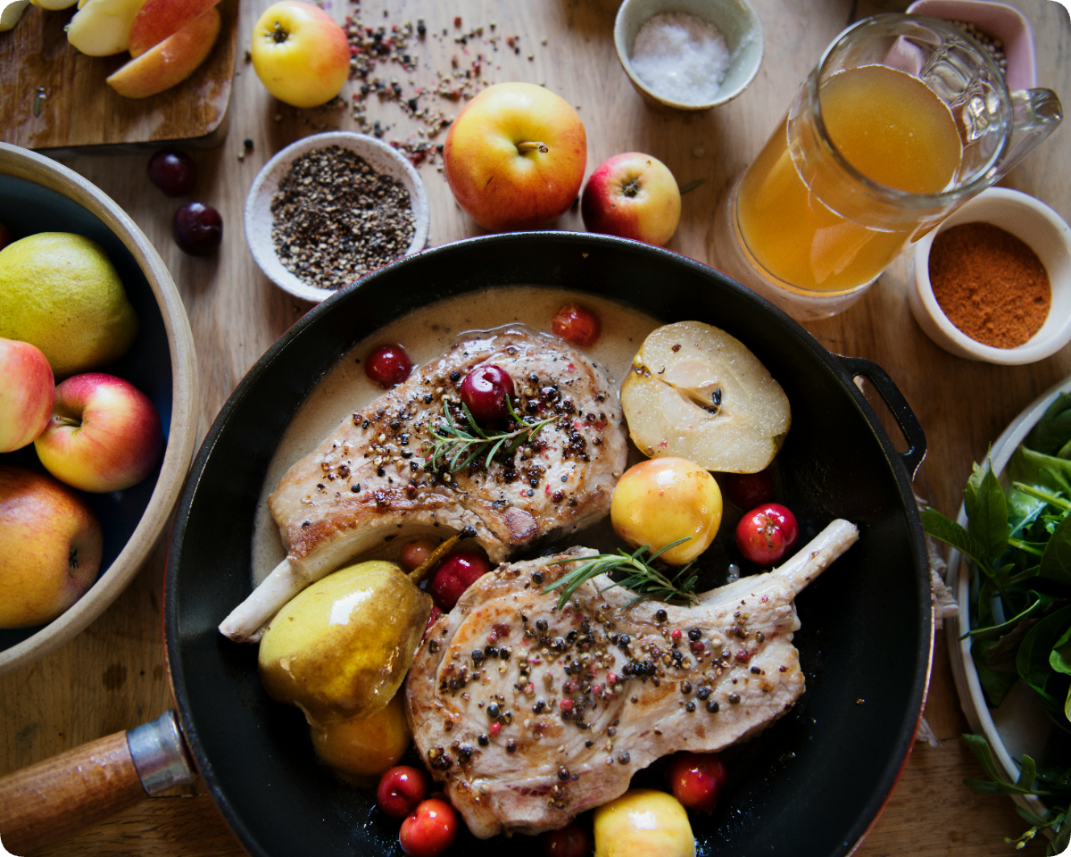 Elegantly plated retreat dinner with roasted meat, fruit, and fresh garnishes