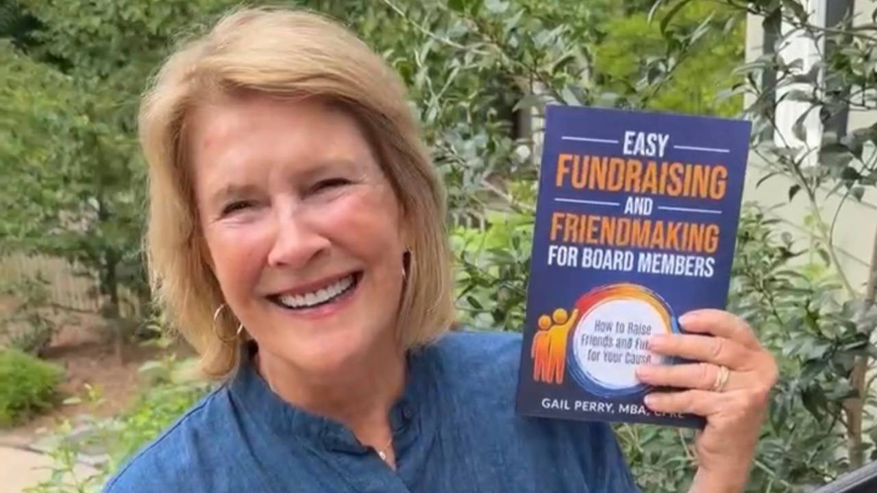 Gail Perry holding her new book, Easy Fundraising and Friendmaking for Board Members