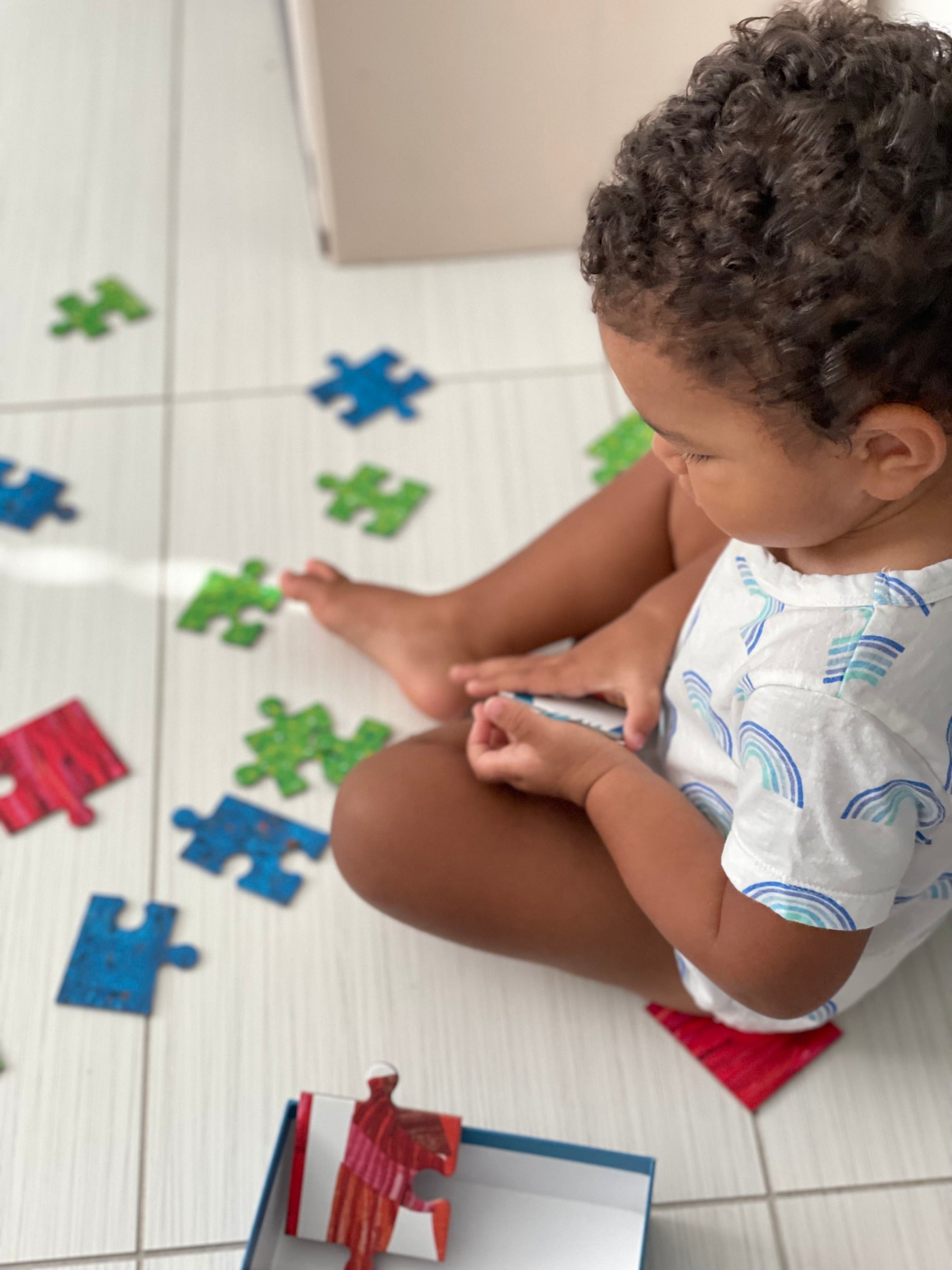Young child learning through play with colorful puzzle pieces