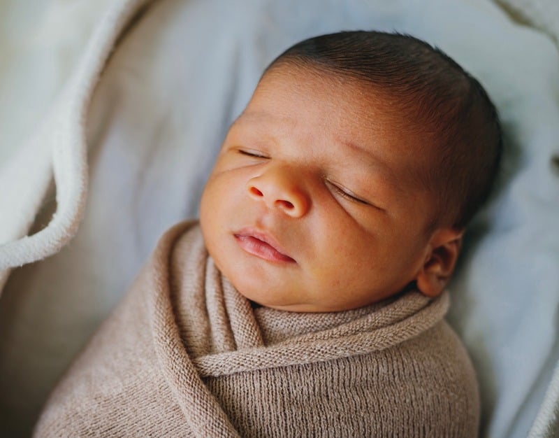 Newborn sleeping safely on their back