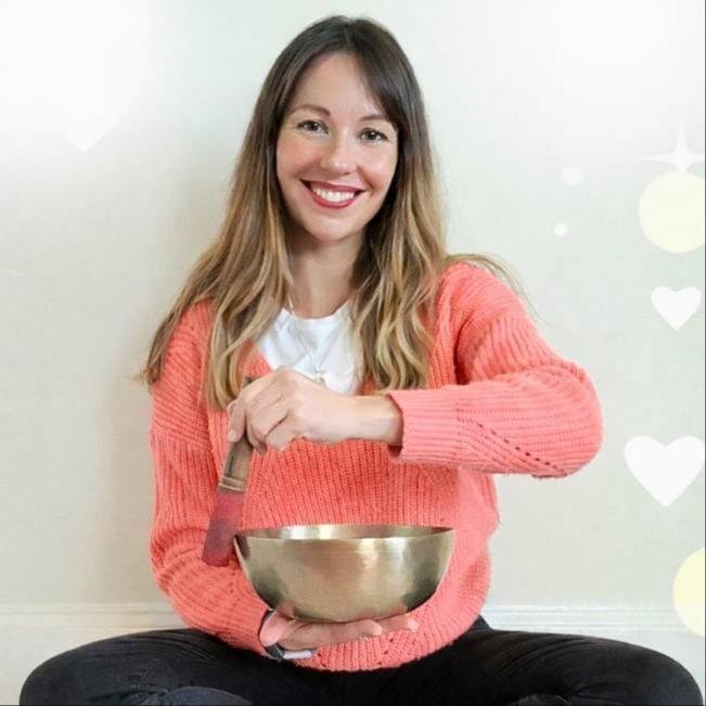 Dr. Aga Religa with a singing bowl