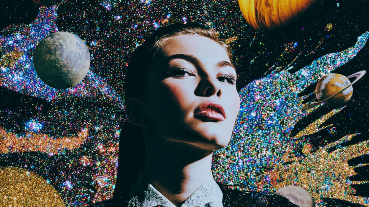 close up of a woman's face as planets and galaxies swirl around her