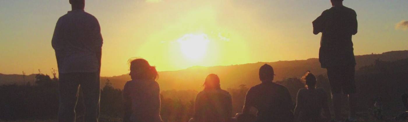 Retreat guests together at sunset