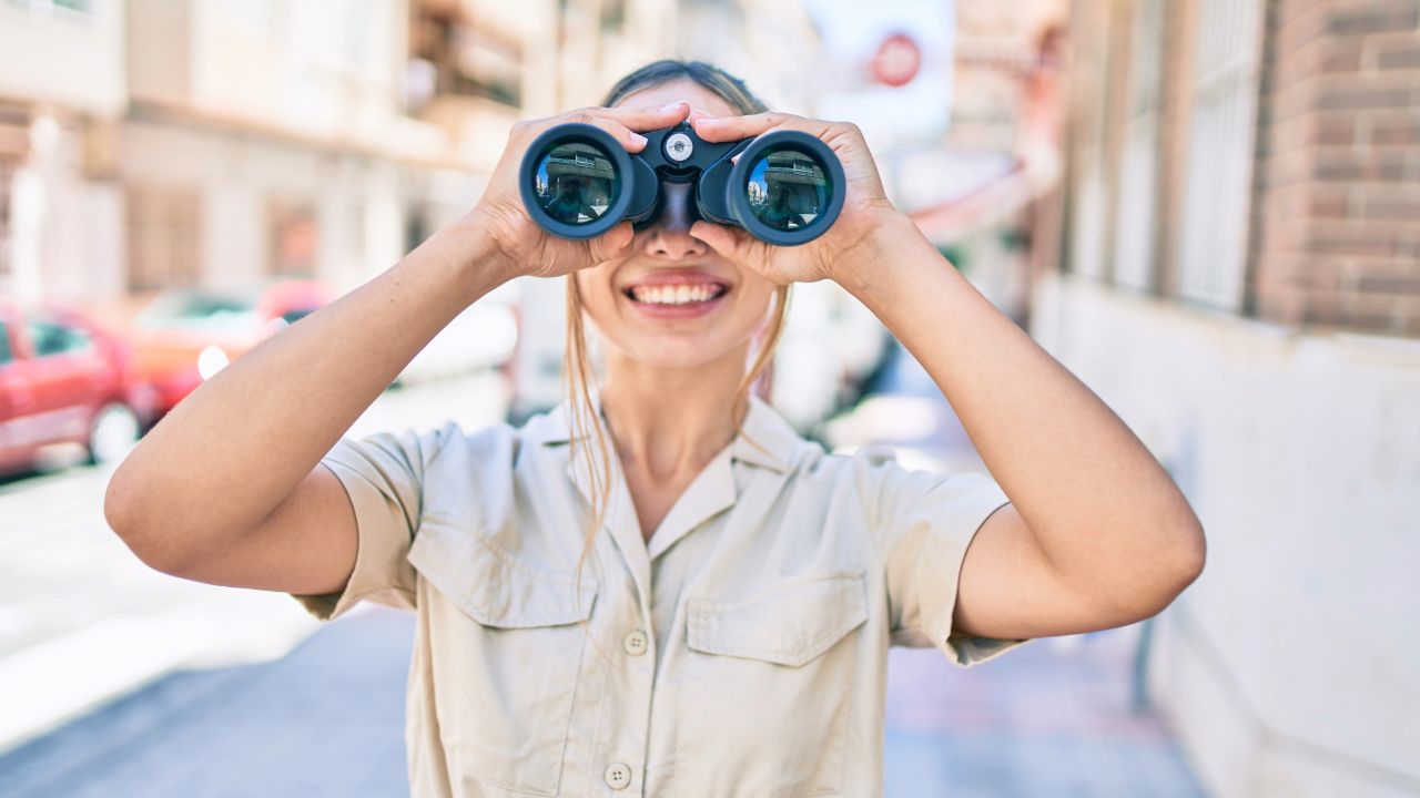 woman holding binoculars