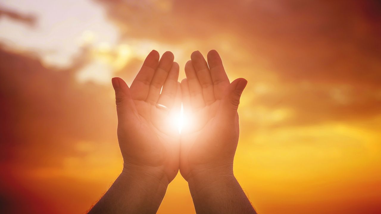 hands holding healing light