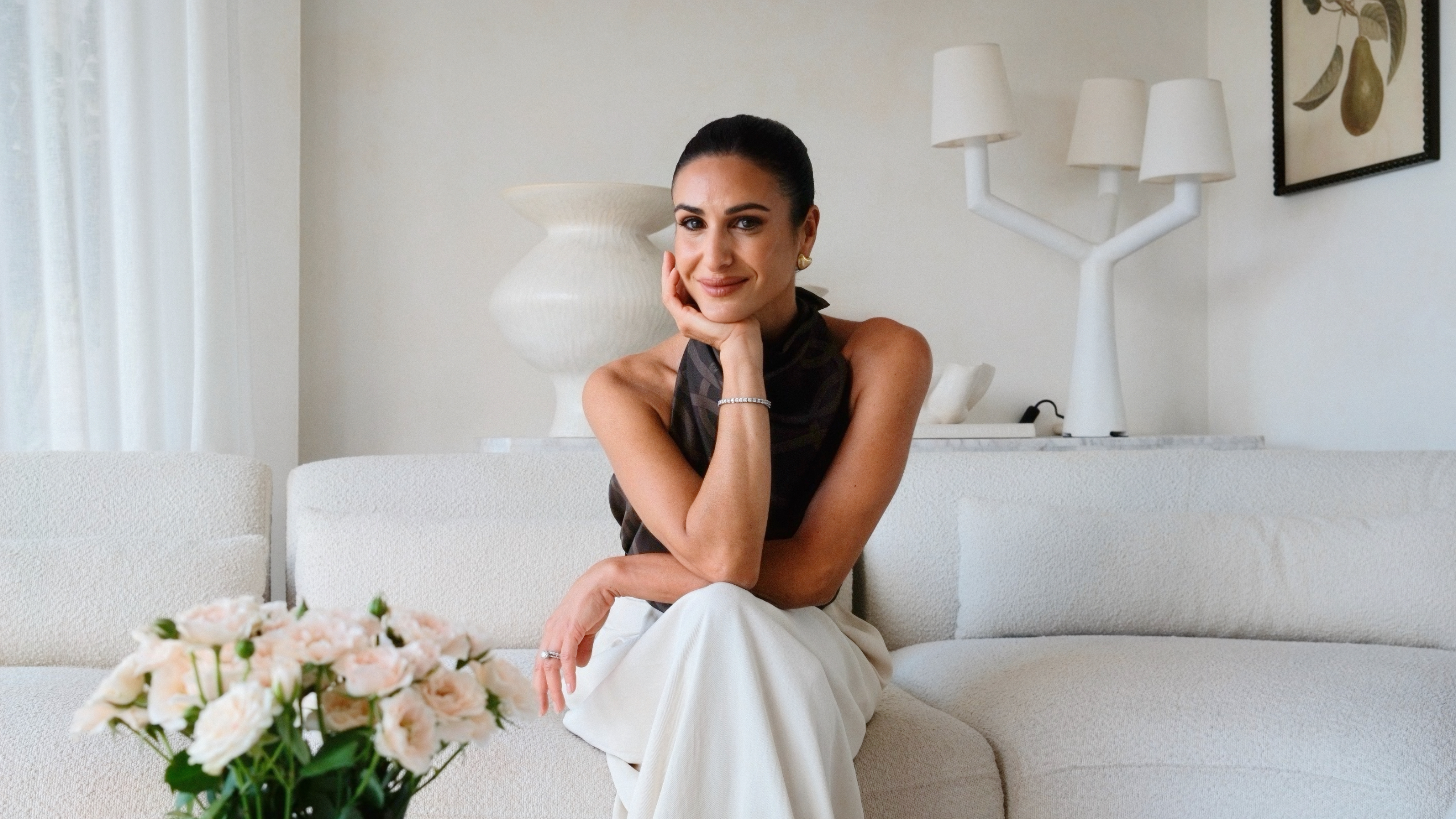 Stephanie Malouf smiling on a couch