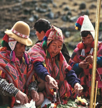 Andean practitioners tending a ceremonial mesa