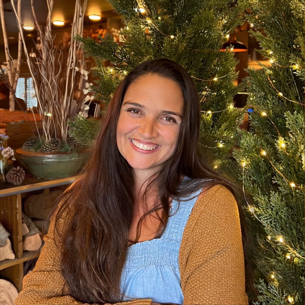 Laura Duncan, founder of The Compassion Method, standing in a cozy living room