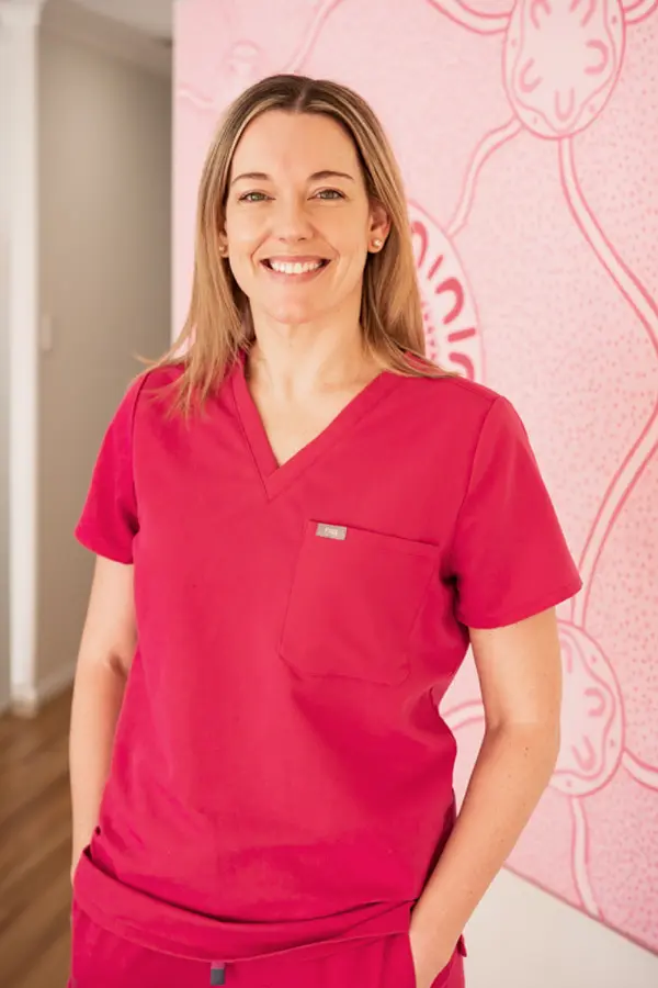 Dr Kate Moriarty supporting a mother and baby