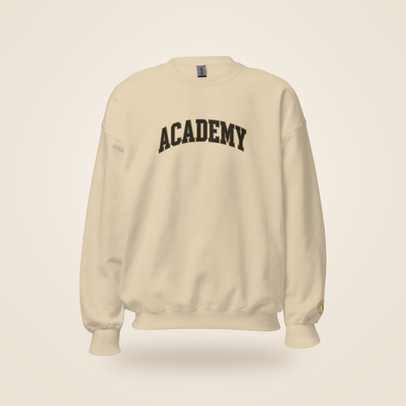 Sand crewneck with ACADEMY arched across the chest