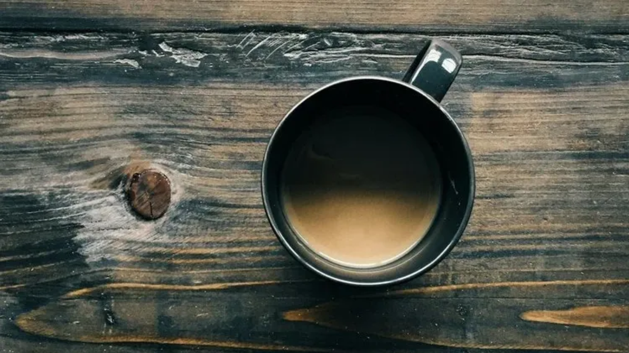 mindful coffee cup on a dark wooden table