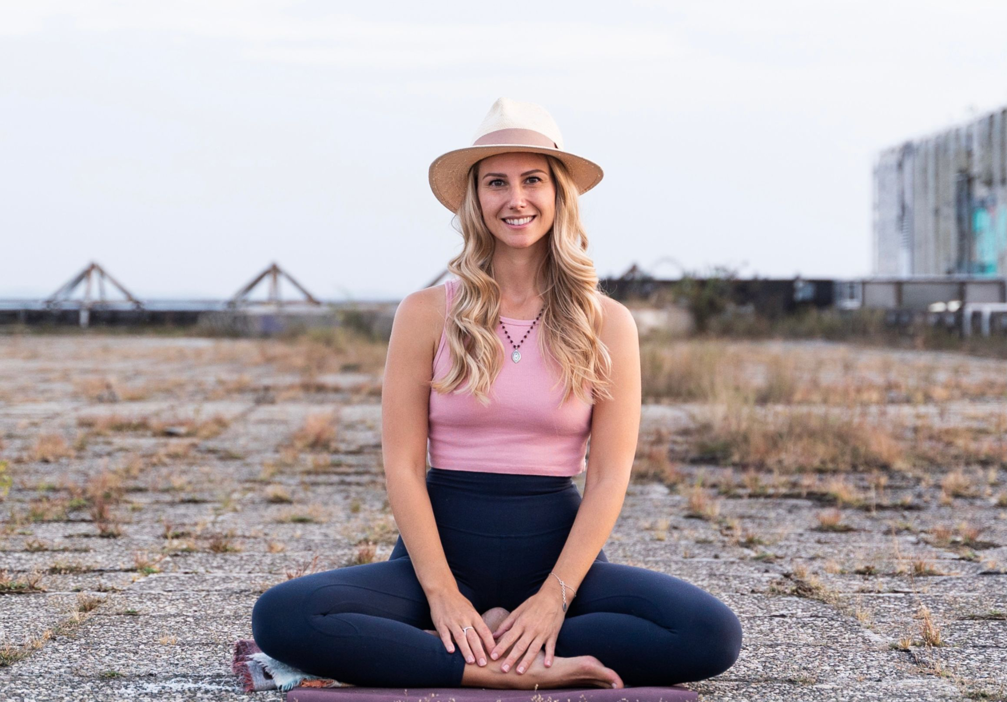 A photo of Rebecca Michelle a personal mindfulness coach from nyc. She is smiling and has a beige hat on.