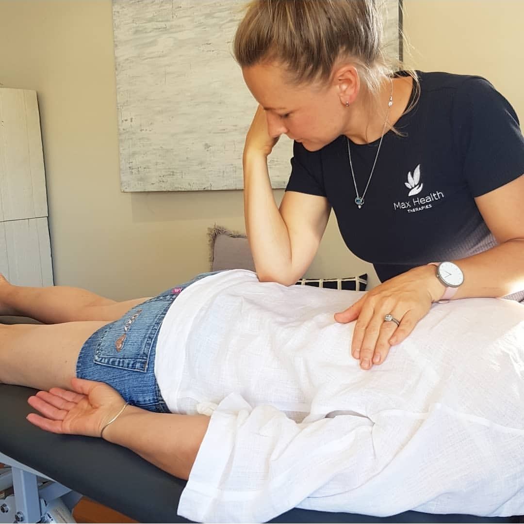 Nicola Wearne demonstrating a hands-on soft tissue technique on the back.