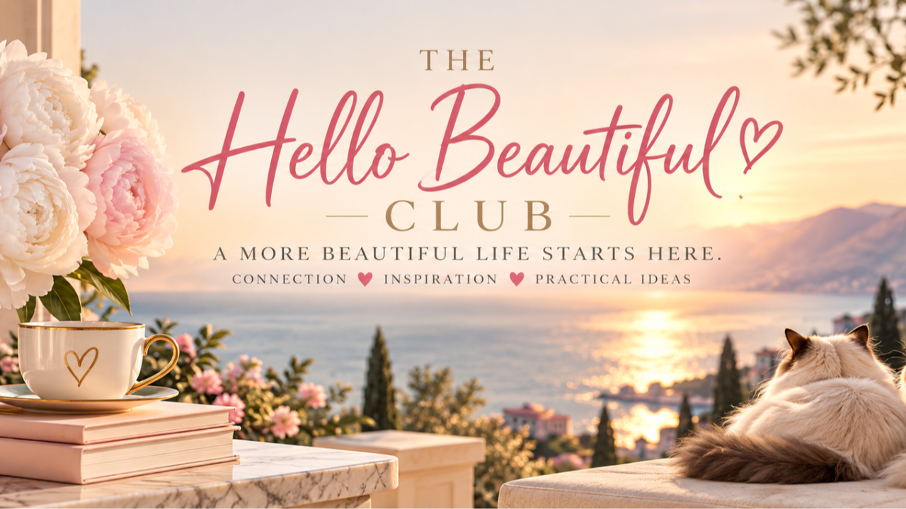 The Hello Beautiful Club overlooking the lake with peonies, books, and a cat