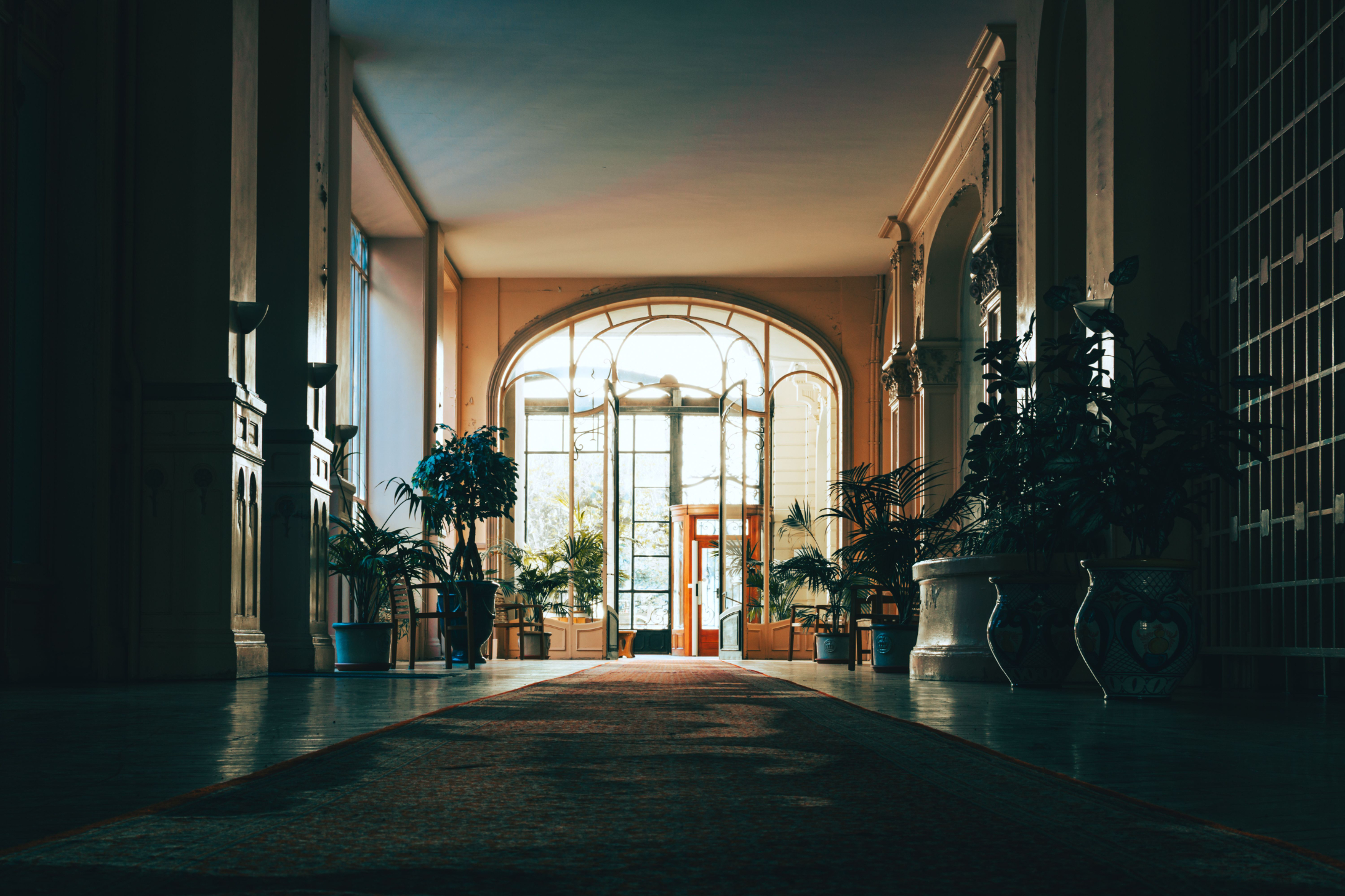 A sunlit villa hallway opening onto a garden