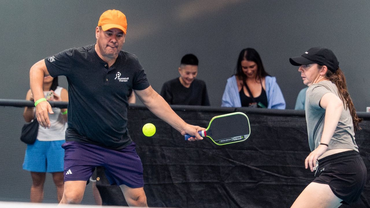 Pickleball coach Tony Roig playing doubles pickleball with a partner.