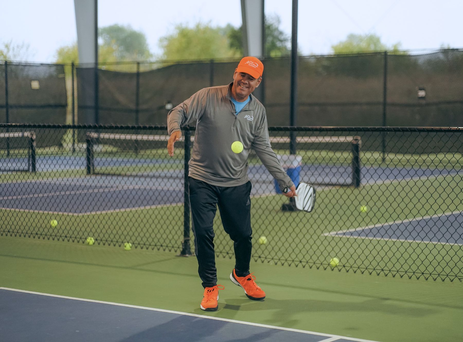 Coach Tony Roig at a pickleball camp demonstrating the serve mechanic