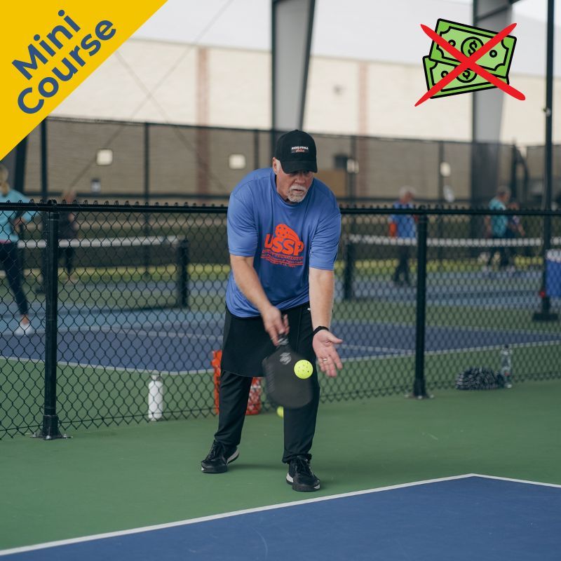 Pickleball player hitting a serve at camp.
