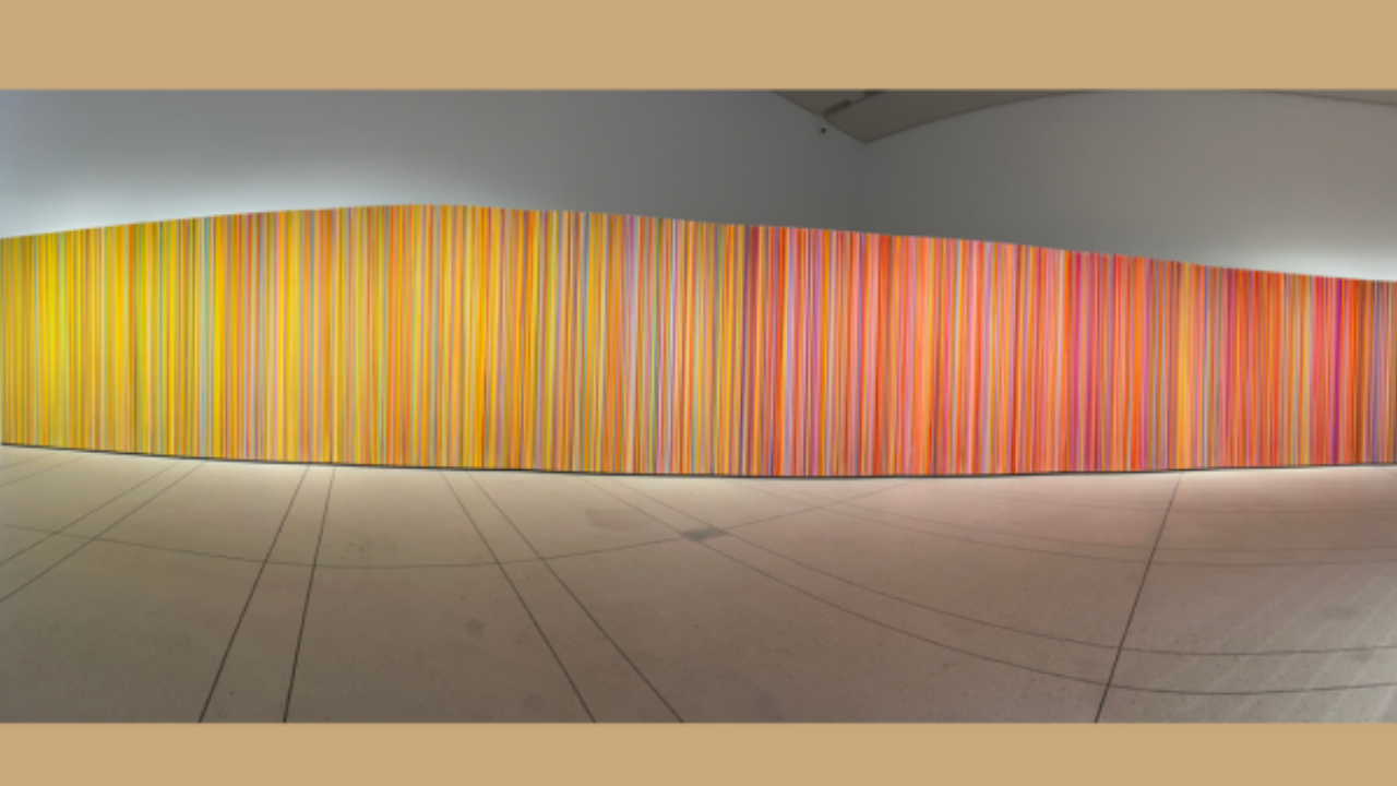 Large abstract painting curving along the wall of a mostly empty gallery room at the Silence Before Sound exhibit in Tampa