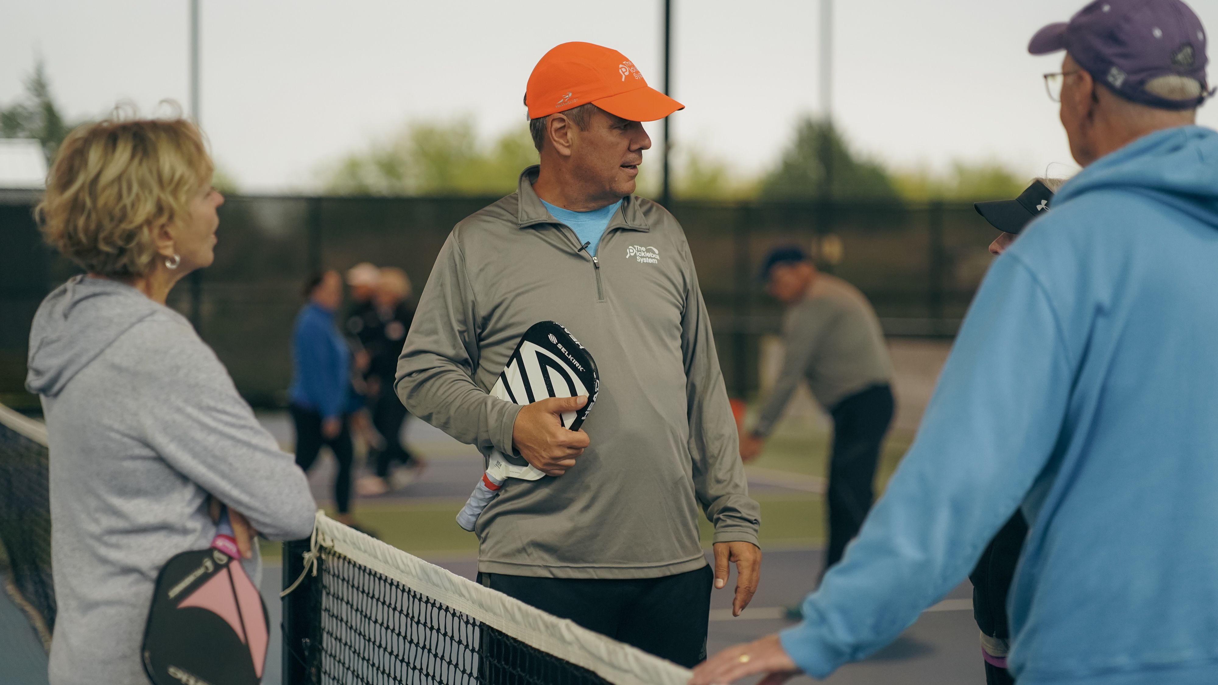 Couple greeting each other at the net after playing pickleball together