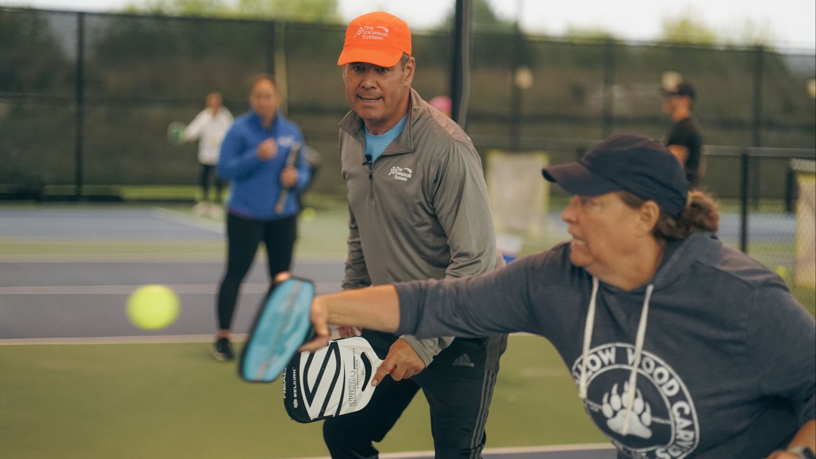 Tony Roig coaching players on court at a TRP pickleball camp