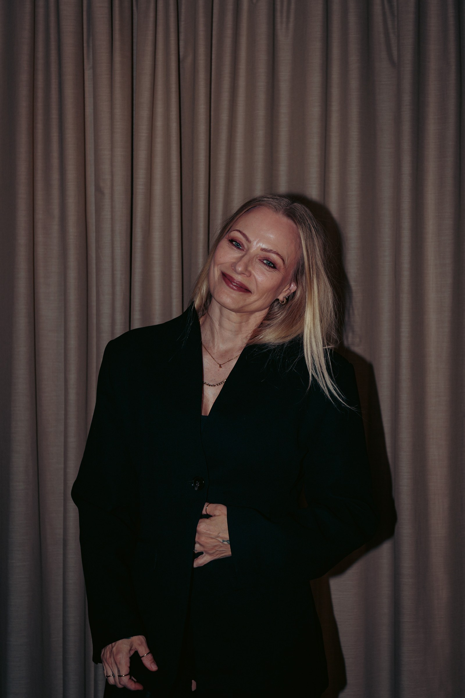 Jonna Nygrén-Jäntti hymyilee verhon edessä