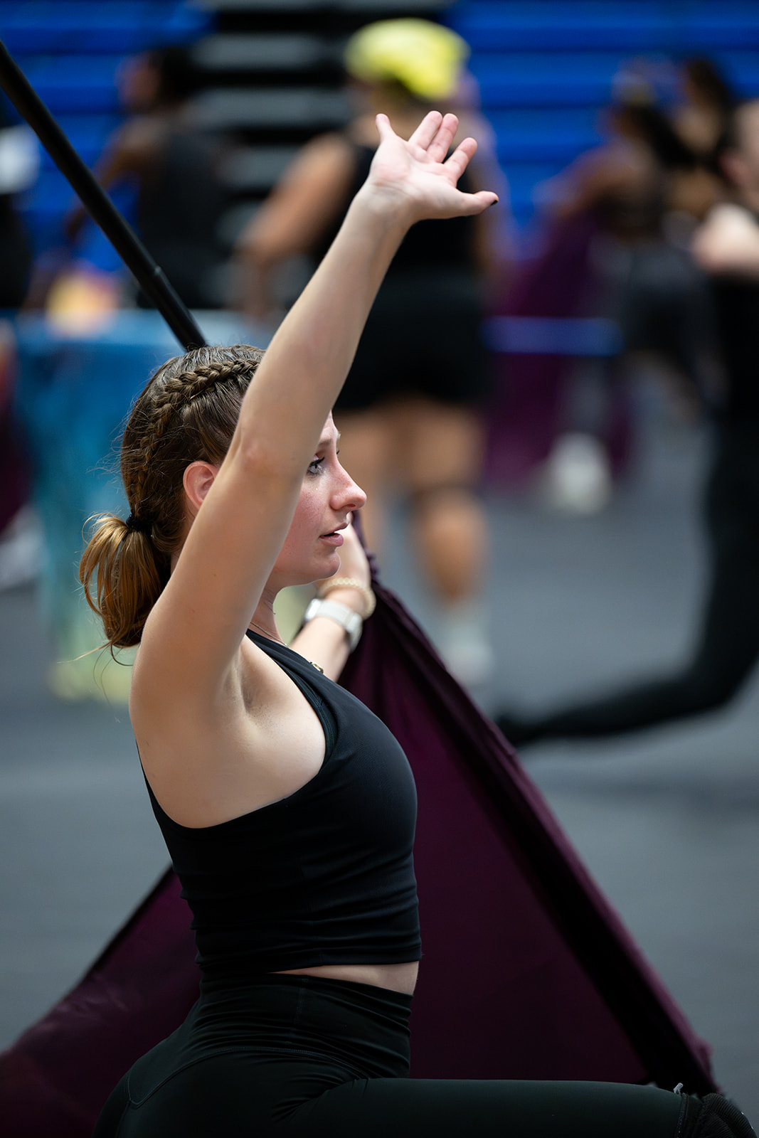 An instructor giving direction to a performer during a flag rehearsal