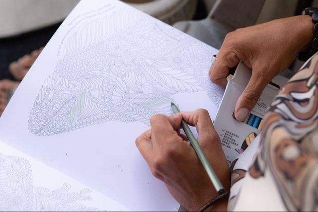 Hands colouring in the Come Home to Yourself workbook