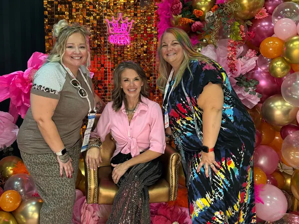 Kayla with two visitors at the hair show.
