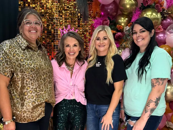 Kayla with three visitors at the hair show.
