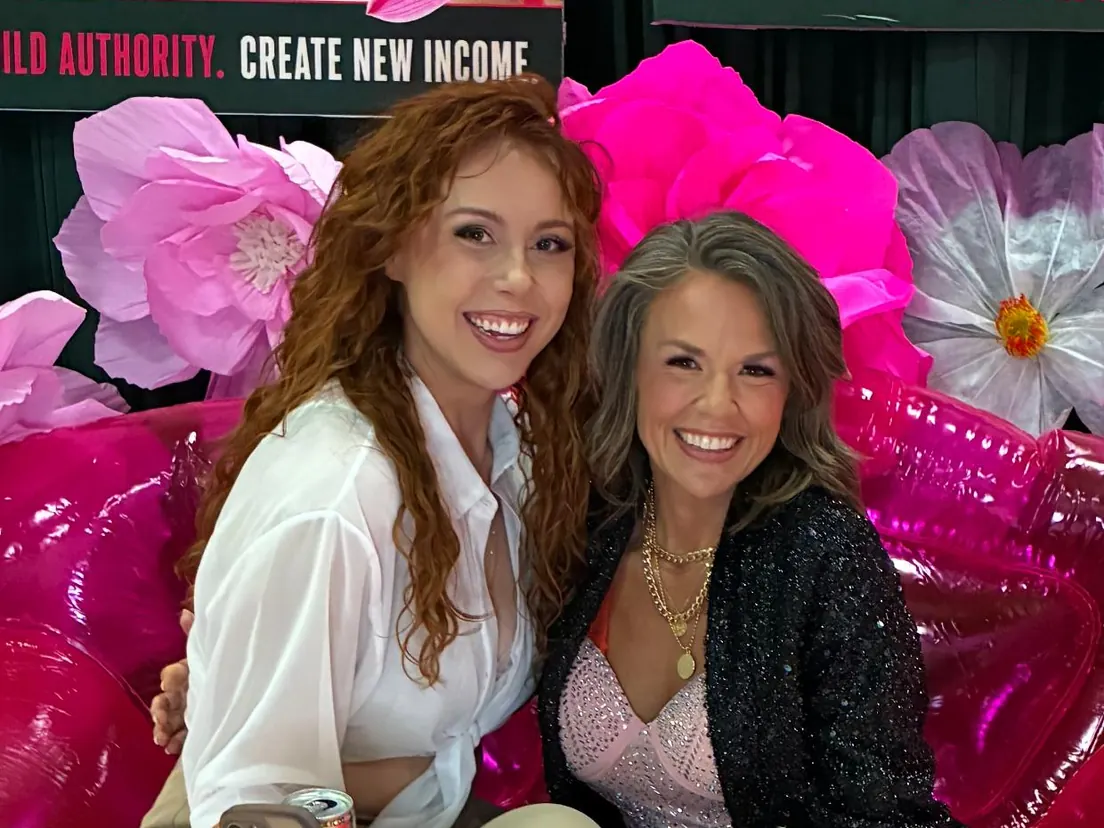 Kayla sharing a friendly moment with a visitor at the hair show.