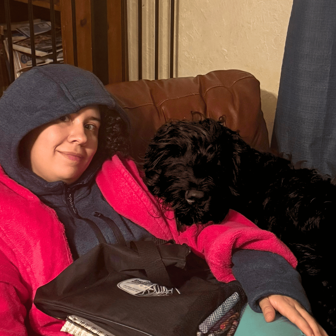 Zhanna climbs onto an armchair with Brittani while she studies, staying close and providing support.