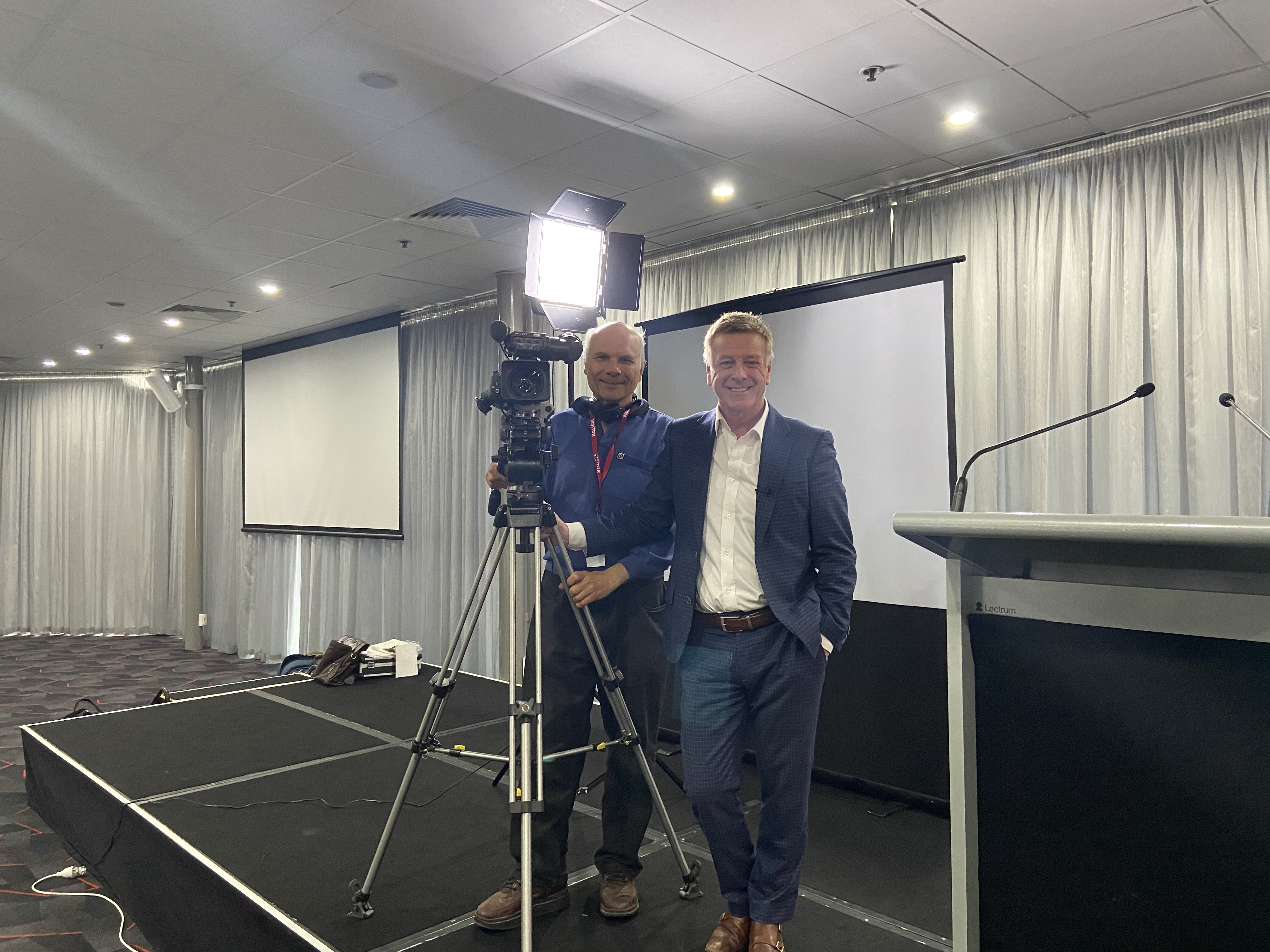 Mark Aiston with cameraman before speaking event