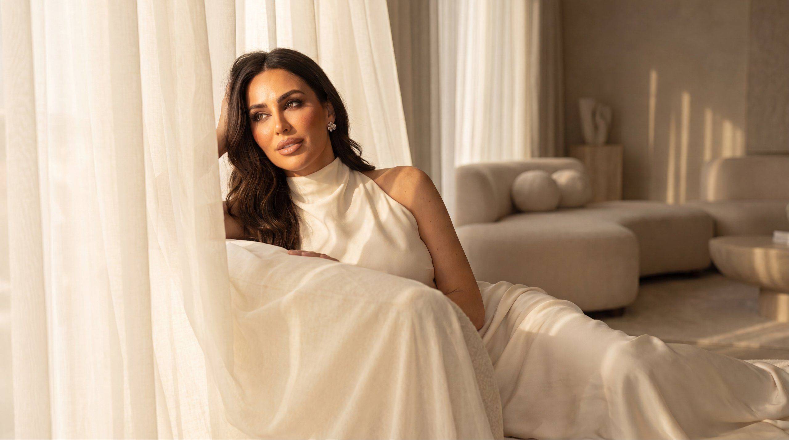 Ouijdane Ayad resting by sheer curtains