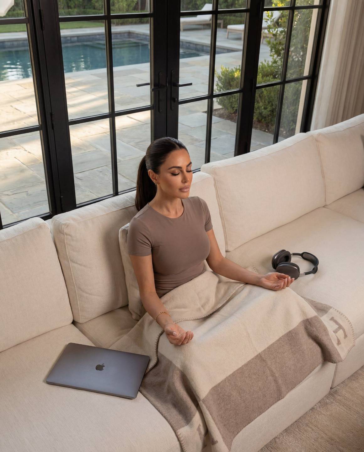 Ouijdane Ayad meditating on a sofa