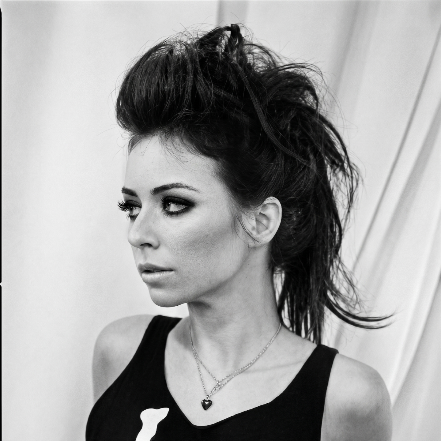 Woman with a voluminous updo hairstyle and dramatic makeup