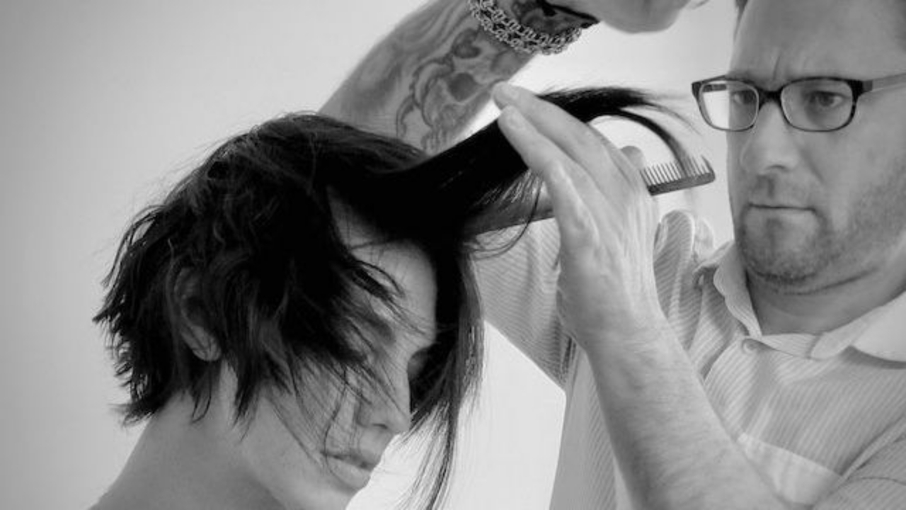 Hairstylist demonstrating a layered haircut