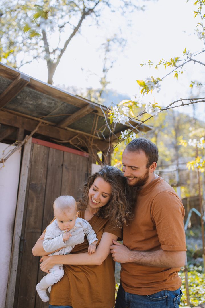 Parents holding their child outdoors