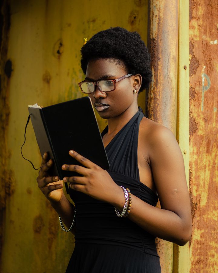 A young adult reading a book