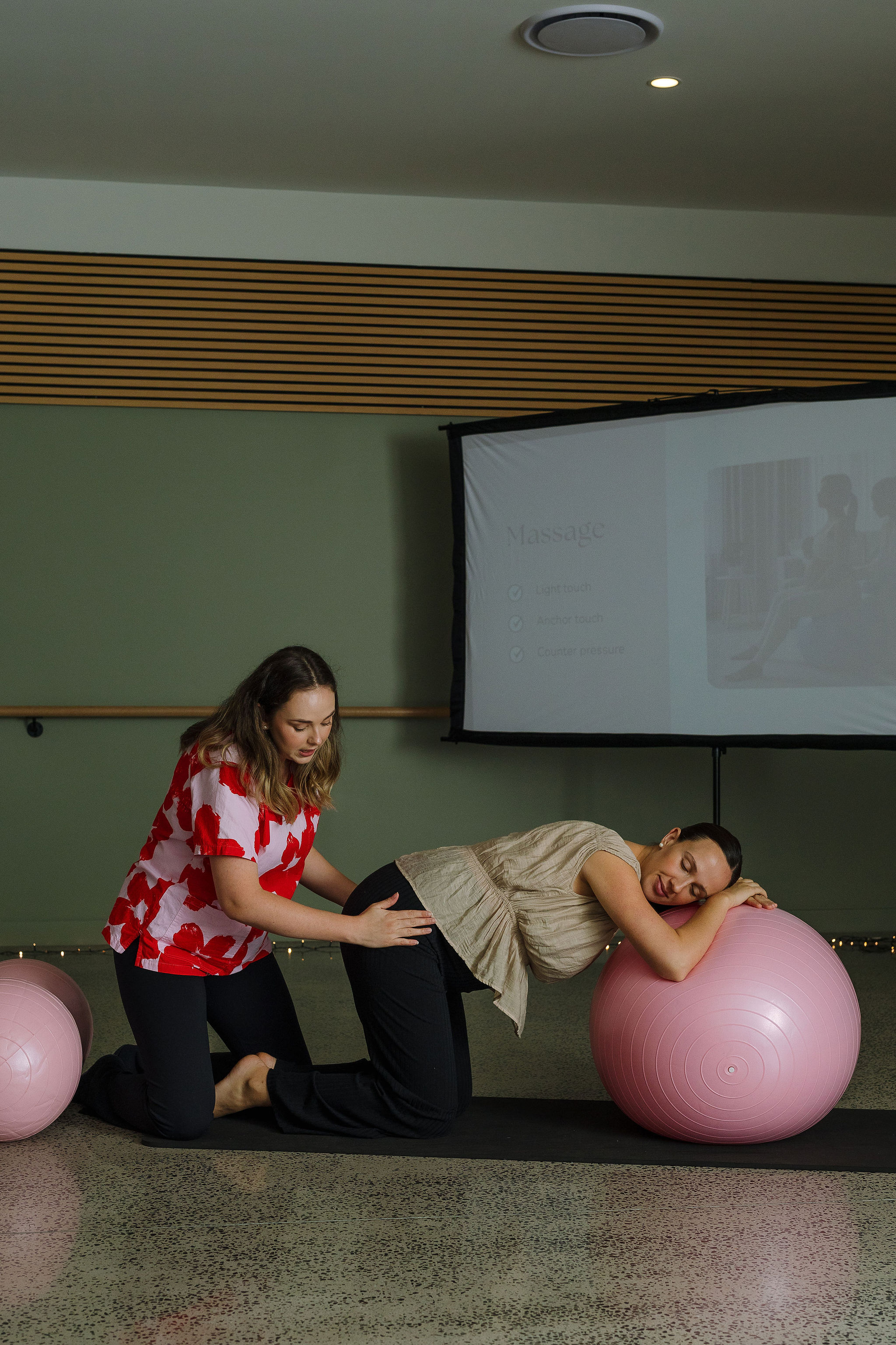 Tam demonstrating massage and counter pressure with a client