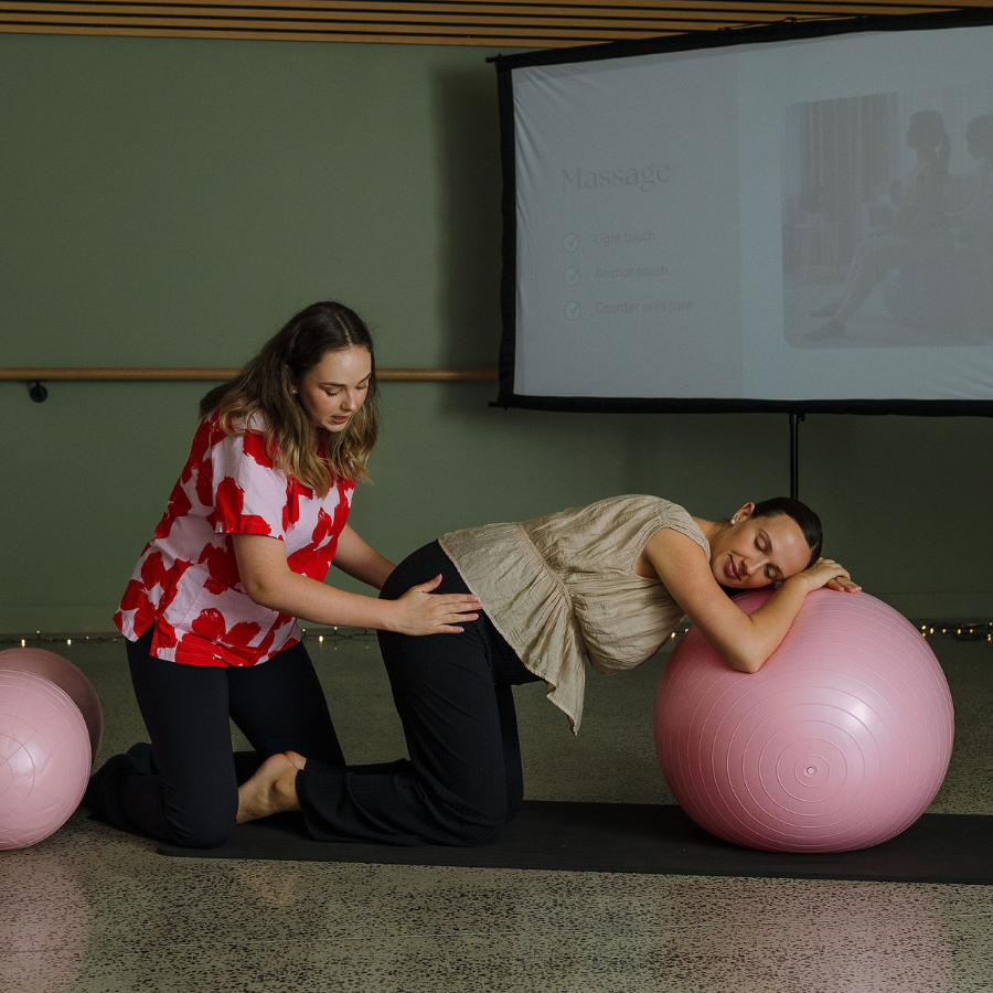 Tam demonstrating massage and counter pressure with a client
