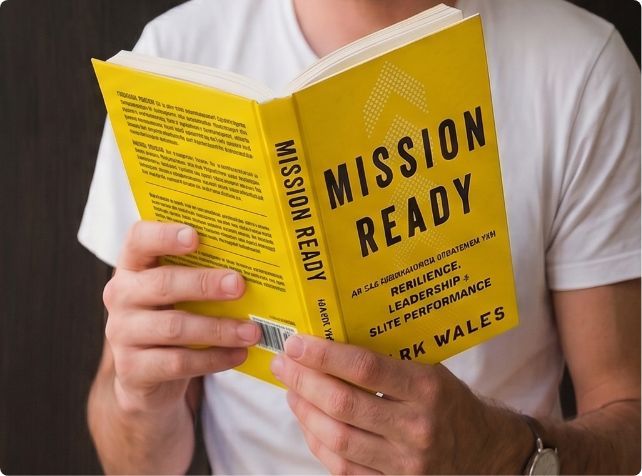 man looking at Mission Ready Book
