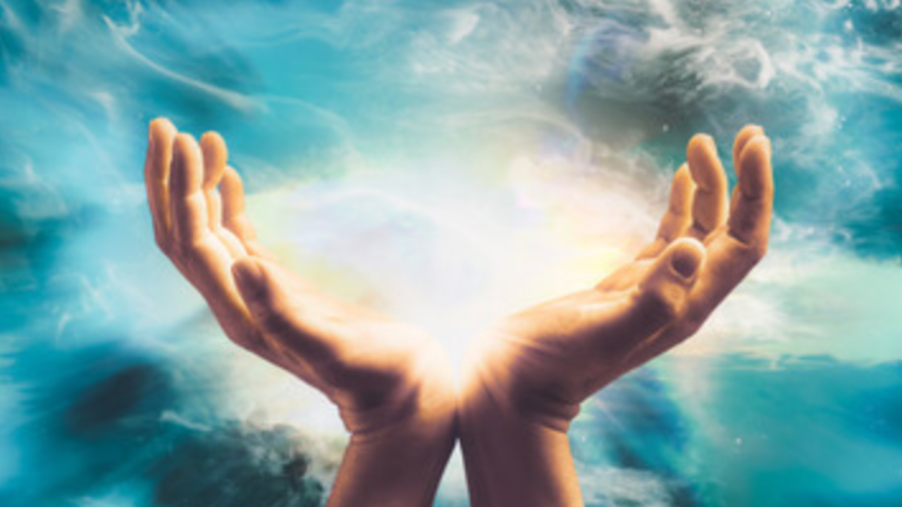 a close, partial view of hands in a Reiki healing position, warm and intimate, works as a visual stand-in for "the practice being passed on