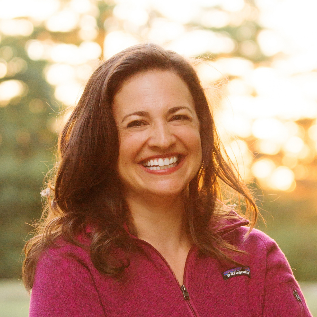 Dr. Jenn Felsted-Knight, leadership coach for women in STEM, smiling outdoors in warm evening light