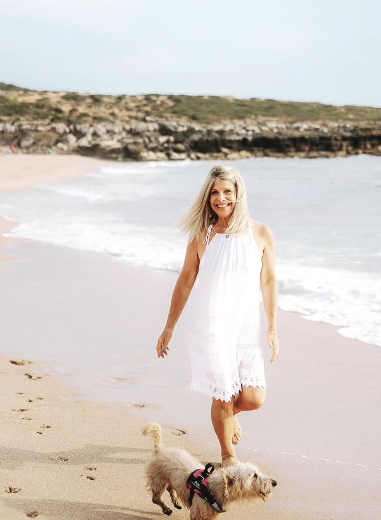 Karen Schachter walking on the beach with her dog